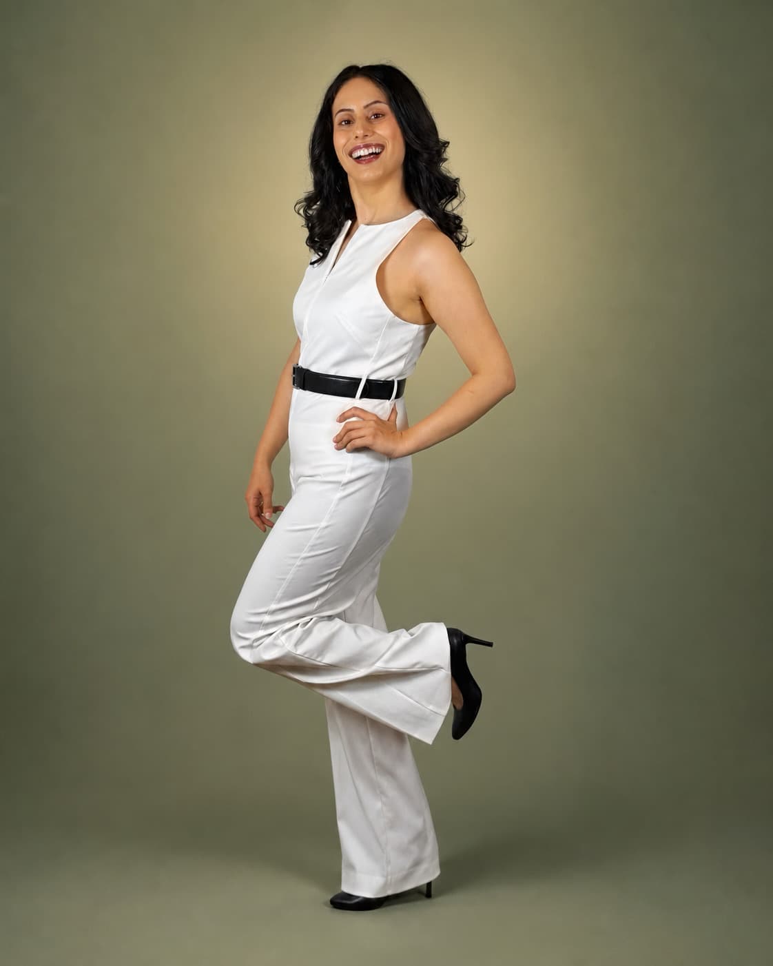 Mina smiling in a full-length studio portrait